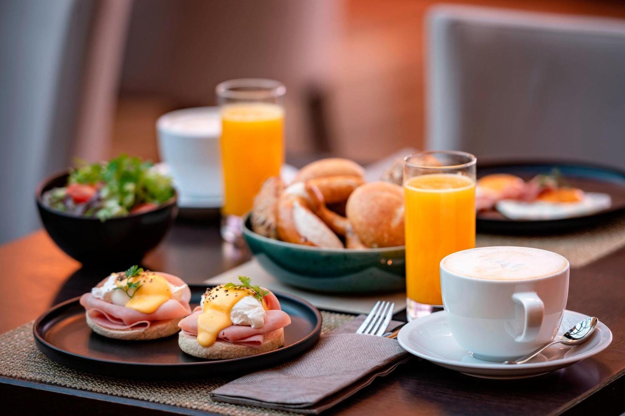 The Westin Grand Munich Hotel Exterior photo A breakfast with orange juice, coffee, and eggs