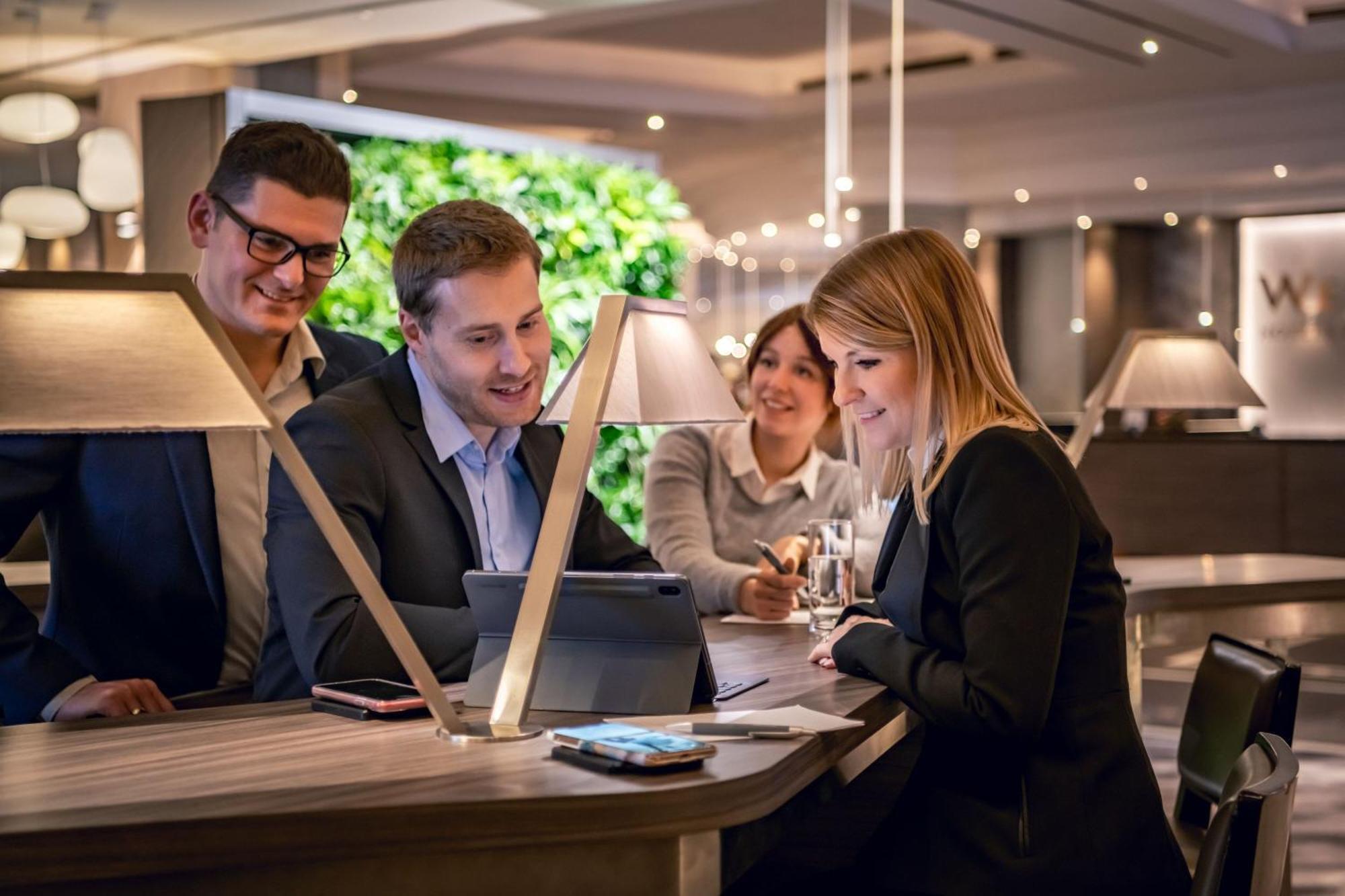 The Westin Grand Munich Hotel Exterior photo Businesspeople working together